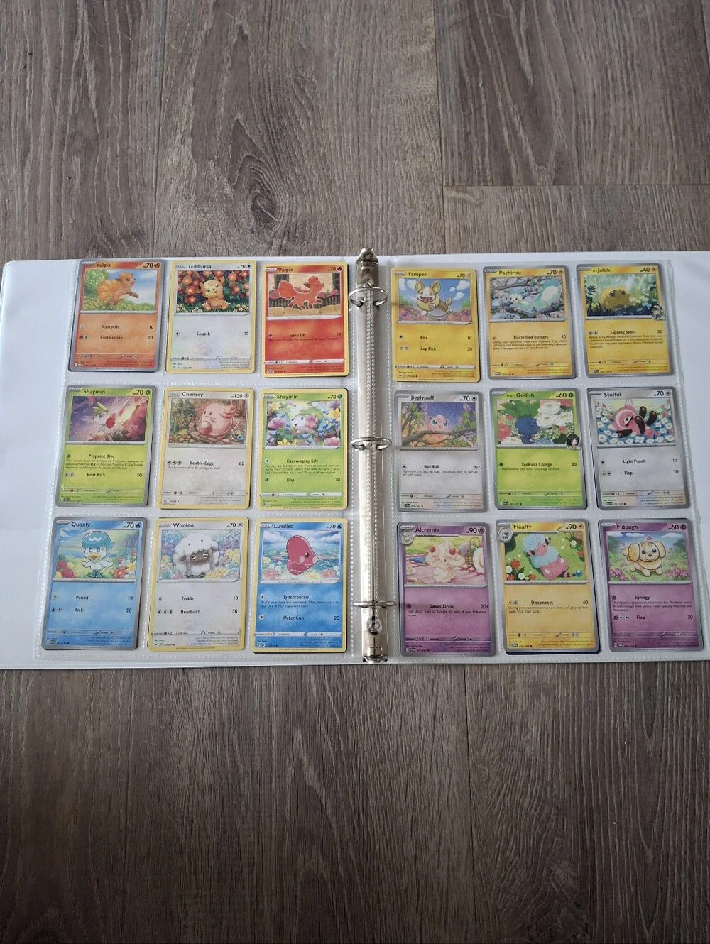 flower themed Pokemon trading cards and green binder